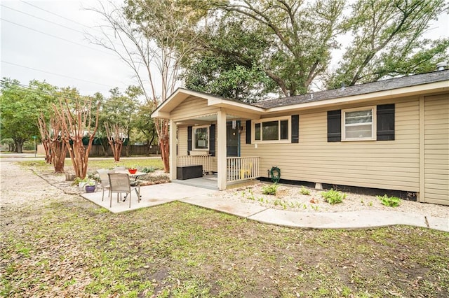 rear view of house featuring a patio area and a lawn