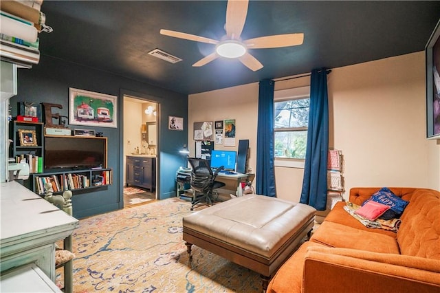 office space with visible vents and ceiling fan