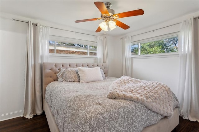 bedroom with baseboards, dark wood-type flooring, and ceiling fan