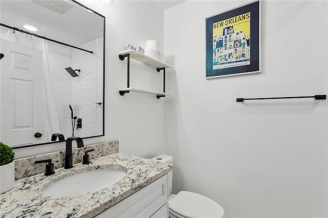 bathroom featuring vanity, a shower with shower curtain, and toilet