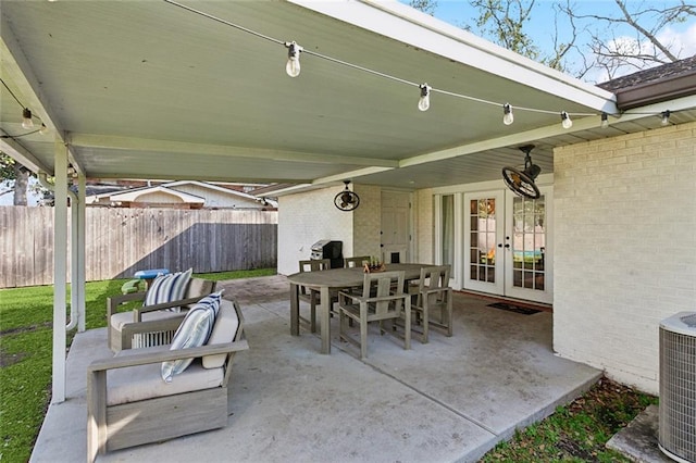 view of patio / terrace featuring french doors, outdoor dining area, central AC, and fence