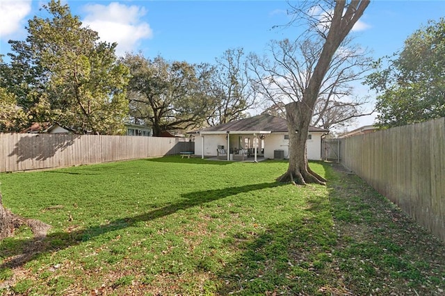 view of yard with cooling unit and a fenced backyard