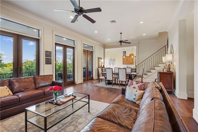 living area with visible vents, stairs, ornamental molding, french doors, and wood finished floors