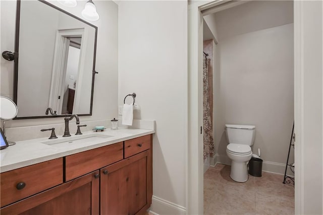 bathroom with toilet, curtained shower, tile patterned flooring, baseboards, and vanity