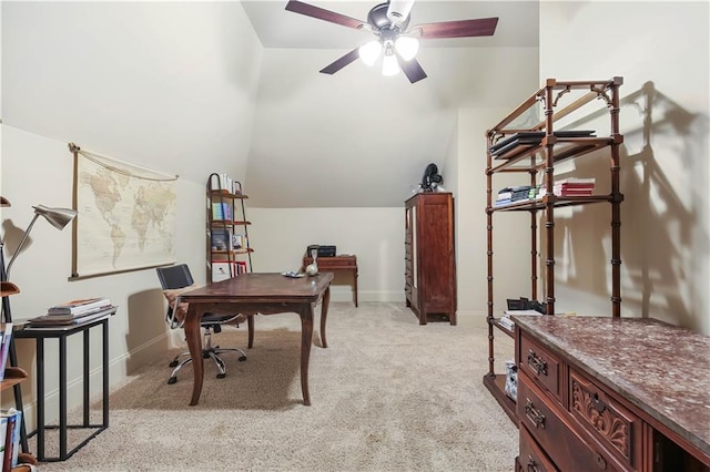 home office featuring light colored carpet, baseboards, lofted ceiling, and a ceiling fan