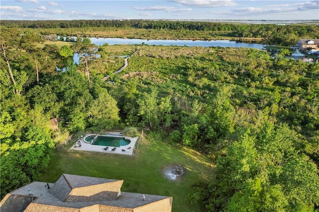 aerial view featuring a wooded view and a water view