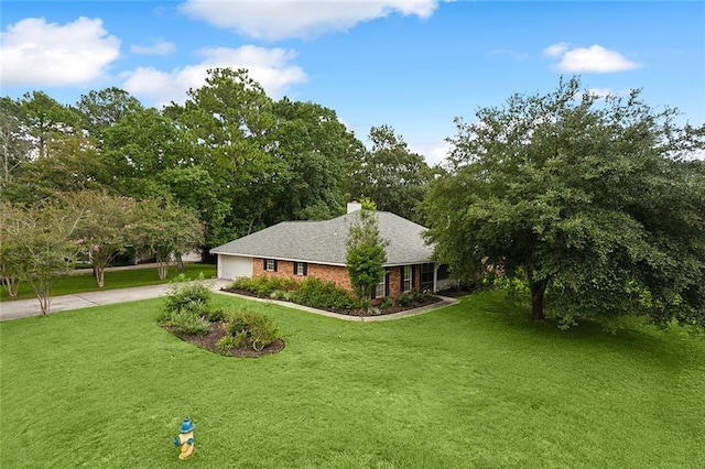 view of front of house featuring brick siding, an attached garage, concrete driveway, and a front lawn