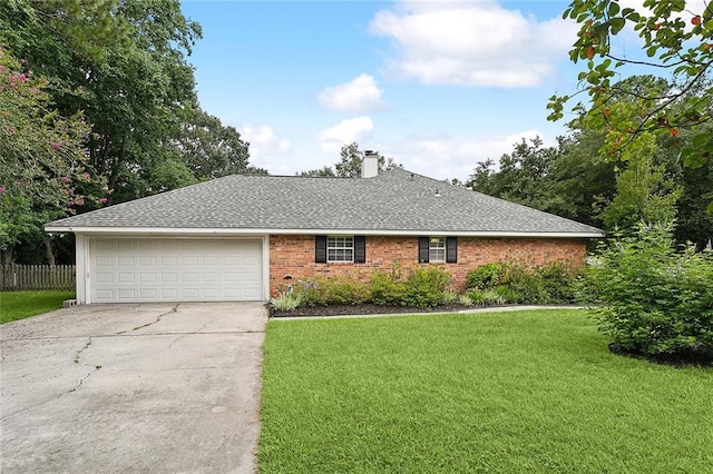 ranch-style home with a shingled roof, concrete driveway, a front yard, a chimney, and an attached garage