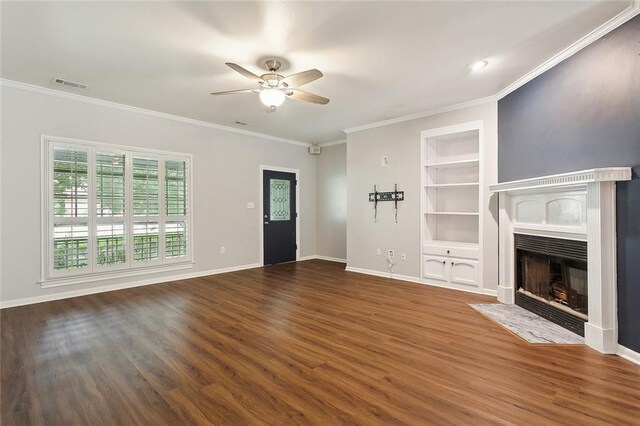 unfurnished living room featuring visible vents, baseboards, a fireplace with flush hearth, built in features, and wood finished floors