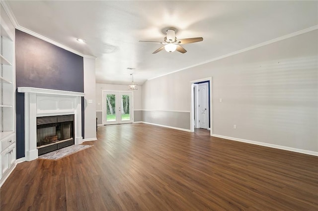 unfurnished living room with baseboards, a fireplace with flush hearth, ceiling fan, dark wood-type flooring, and crown molding