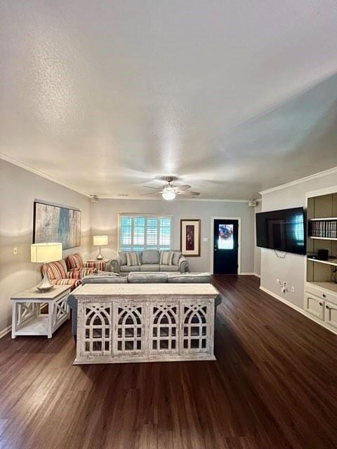 unfurnished living room featuring dark wood finished floors, crown molding, and baseboards