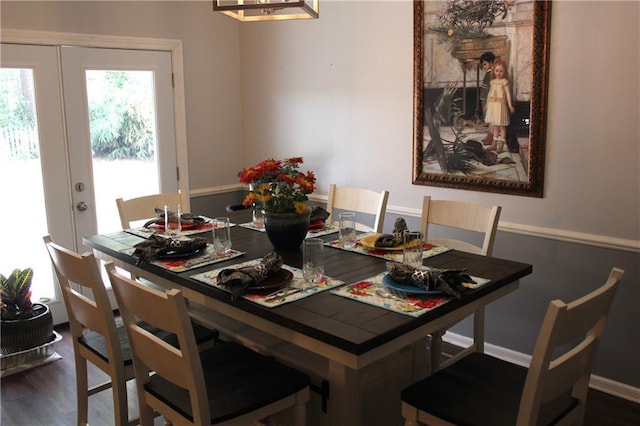 dining space featuring wood finished floors, french doors, and baseboards