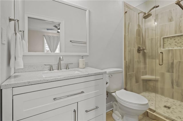 full bath with a shower stall, toilet, and vanity