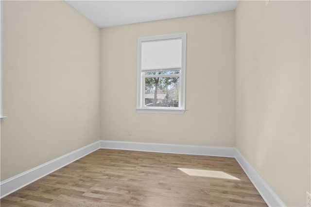 empty room featuring baseboards and wood finished floors