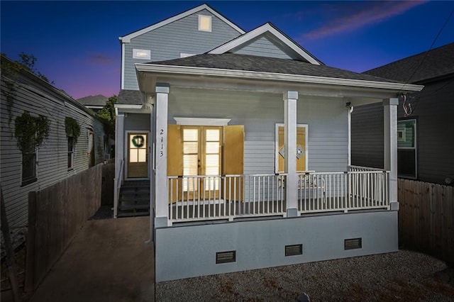 view of front of house featuring crawl space, covered porch, roof with shingles, and fence