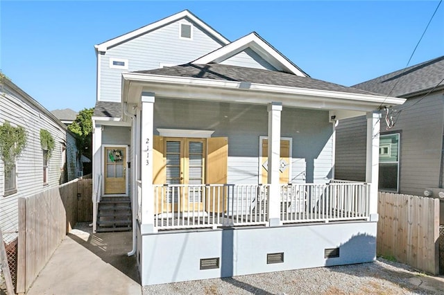 shotgun-style home featuring fence, roof with shingles, a porch, french doors, and crawl space