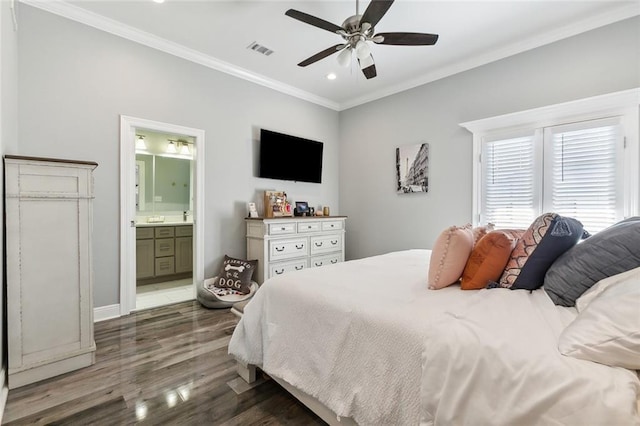 bedroom with visible vents, ornamental molding, wood finished floors, ensuite bath, and a ceiling fan