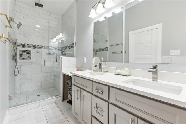 full bathroom with double vanity, a stall shower, marble finish floor, and a sink