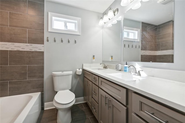 full bathroom featuring tile patterned floors, toilet, double vanity, and a sink