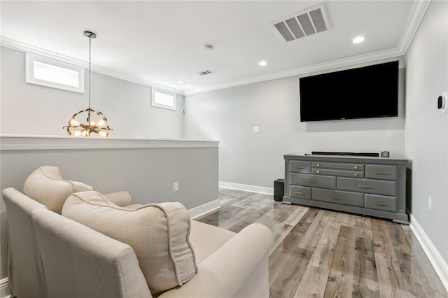 living room featuring visible vents, baseboards, a notable chandelier, and crown molding