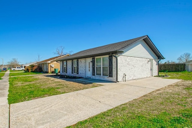 ranch-style house with a front lawn, fence, and brick siding