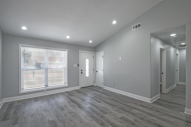 entryway with visible vents, baseboards, lofted ceiling, and wood finished floors