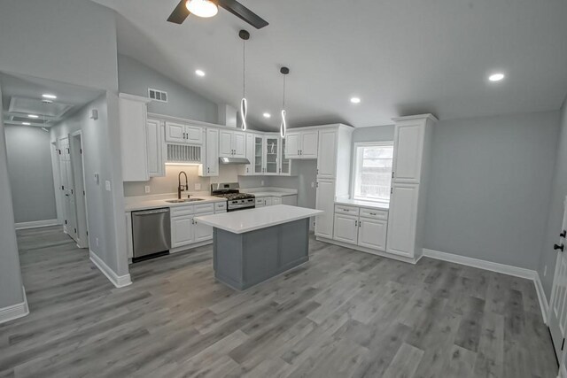 kitchen featuring visible vents, light countertops, stainless steel appliances, white cabinetry, and a sink