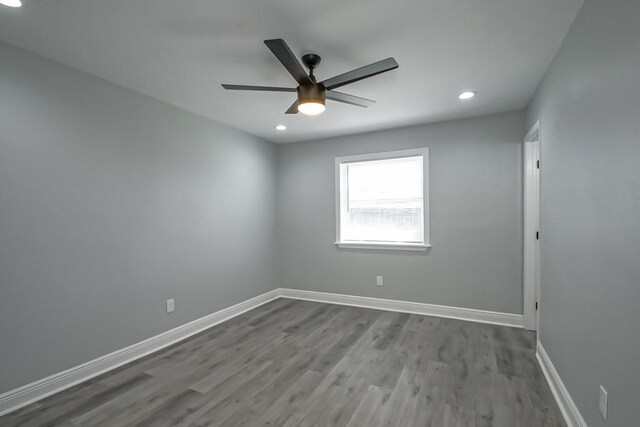 spare room featuring recessed lighting, baseboards, wood finished floors, and a ceiling fan