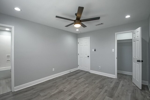 unfurnished bedroom with visible vents, dark wood finished floors, recessed lighting, a closet, and baseboards