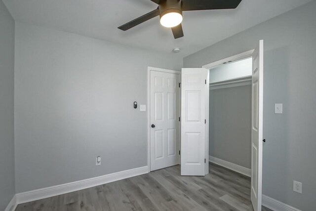 unfurnished bedroom featuring baseboards and wood finished floors