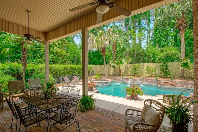 view of pool with a pool with connected hot tub, a patio, a ceiling fan, and a fenced backyard