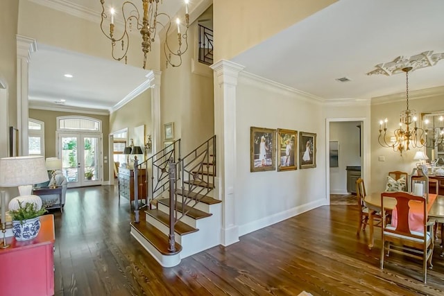 interior space with a chandelier, stairway, decorative columns, french doors, and wood finished floors