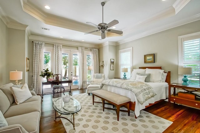 bedroom with access to exterior, visible vents, crown molding, a tray ceiling, and dark wood-style floors