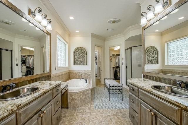 full bath with ornamental molding, a bath, a shower stall, and a sink
