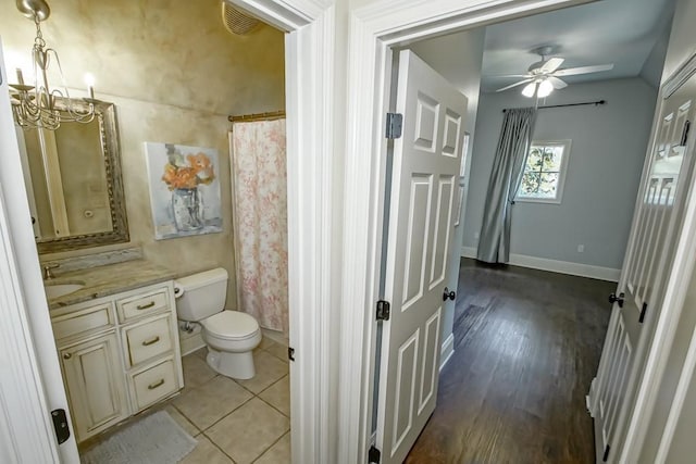 bathroom featuring visible vents, toilet, ceiling fan with notable chandelier, tile patterned flooring, and vanity