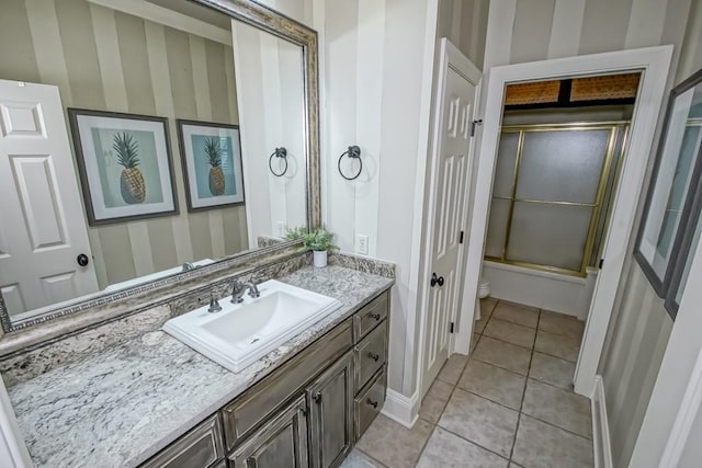 full bath with tile patterned floors, wallpapered walls, and vanity