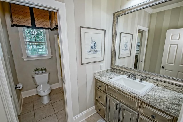 bathroom featuring baseboards, toilet, vanity, and tile patterned flooring