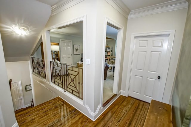 corridor with baseboards, dark wood-type flooring, and crown molding