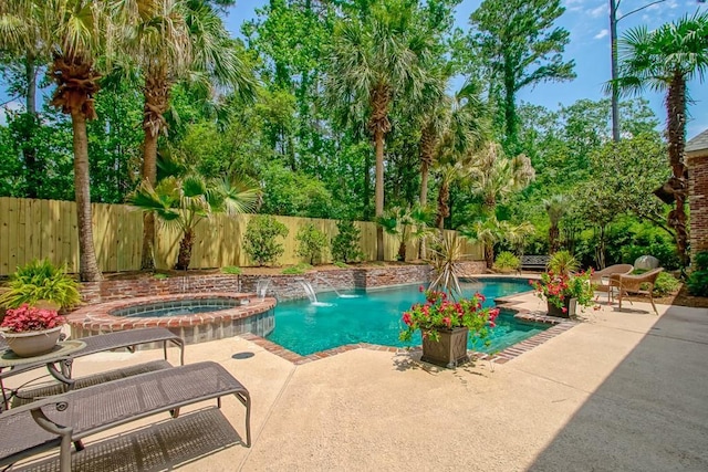 view of pool with a pool with connected hot tub, a fenced backyard, and a patio area
