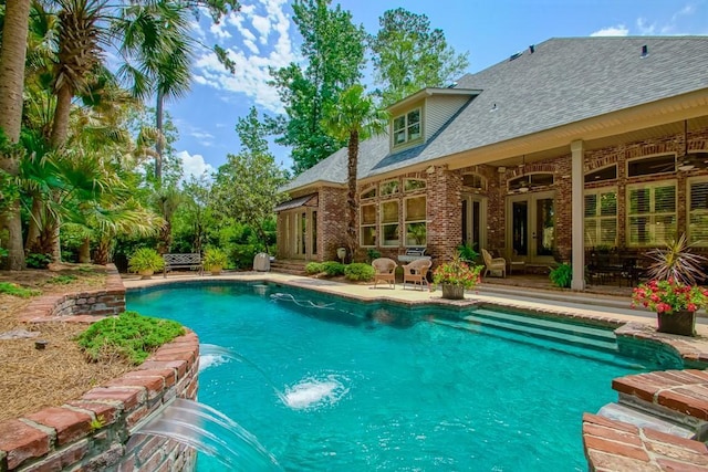 outdoor pool featuring french doors and a patio area