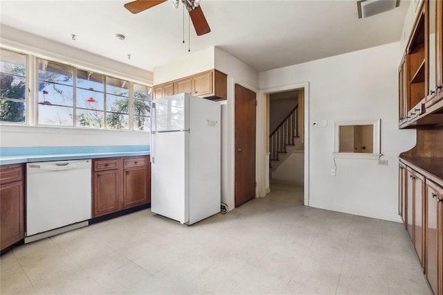 kitchen with brown cabinetry, white appliances, a ceiling fan, and open shelves