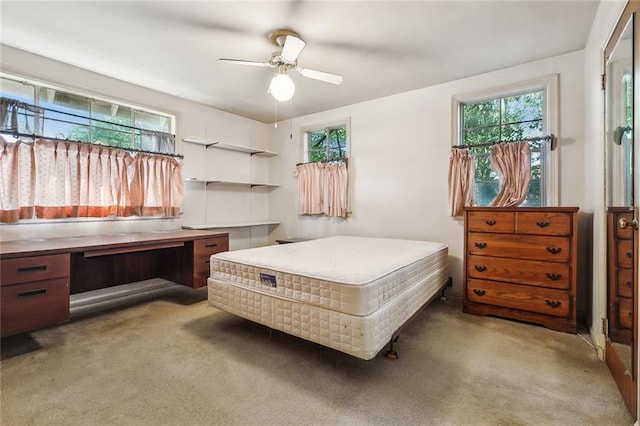 bedroom featuring ceiling fan and light carpet