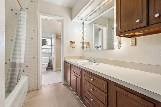 bathroom featuring tile patterned flooring, shower / bath combo with shower curtain, toilet, and vanity