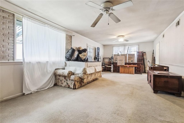 sitting room with ceiling fan, visible vents, carpet floors, and ornamental molding