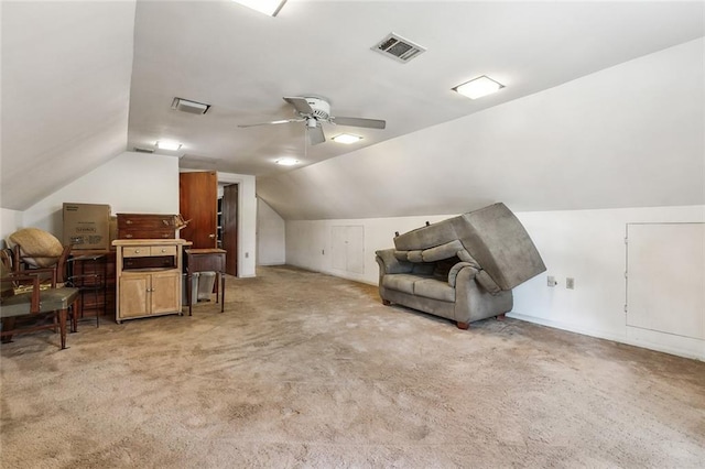 sitting room with visible vents, lofted ceiling, light colored carpet, and a ceiling fan