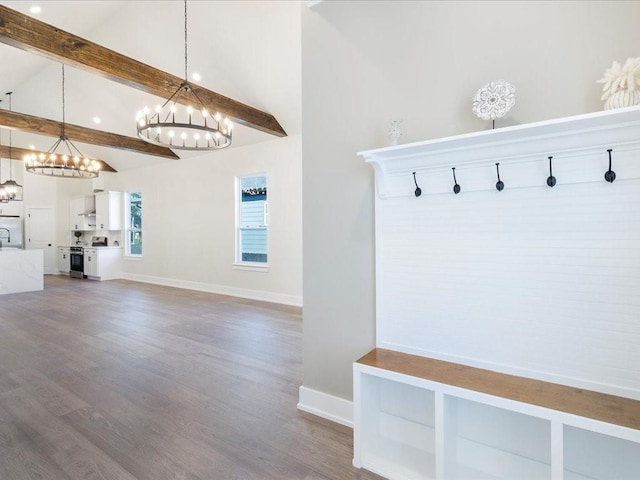 mudroom featuring beamed ceiling, wood finished floors, baseboards, and high vaulted ceiling