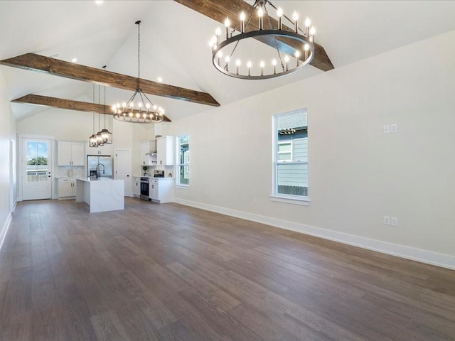 unfurnished living room featuring beamed ceiling, dark wood-type flooring, high vaulted ceiling, an inviting chandelier, and baseboards