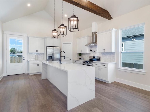 kitchen with a sink, white cabinetry, appliances with stainless steel finishes, wall chimney exhaust hood, and dark wood-style flooring