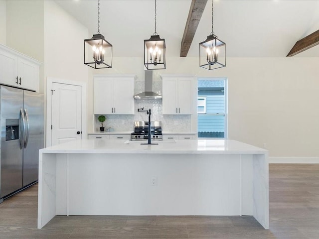 kitchen featuring beamed ceiling, light countertops, decorative backsplash, stainless steel appliances, and wall chimney exhaust hood