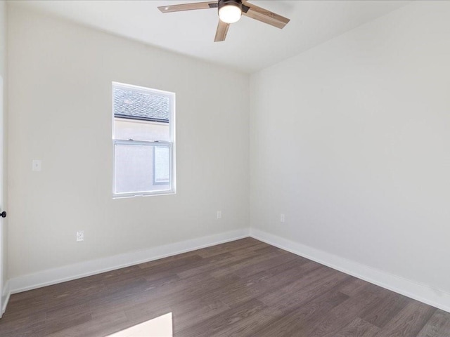 empty room featuring ceiling fan, baseboards, and wood finished floors